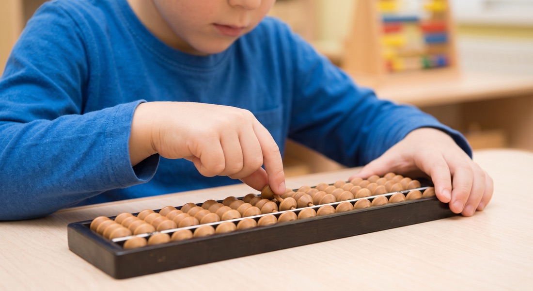 A child moving beads on an abacus